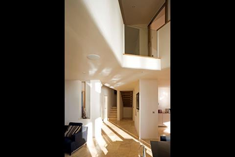 Plastered gallery soffits are continued to form upstands.